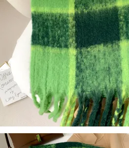 Green plaid plush scarf detail, cozy winter tassel design close up, soft warm fashion neck wrap.