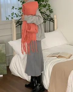 Detail view of the thick mohair winter scarf with cozy tassels and solid color design.