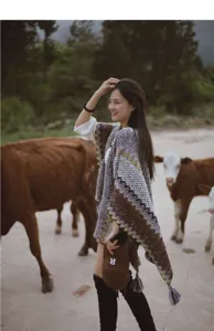 Ethnic style knitted poncho cape for women, retro geometric pattern shawl with tassels for travel.