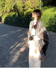 Ethnic style knitted tassel shawl, perfect for travel outfits and casual wear. Detail view.