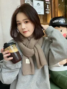 Detailed view of women winter khaki knitted scarf, thick warm woolen neck wrap for daily wear.