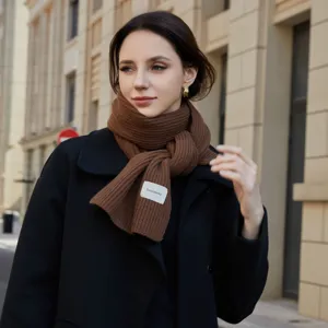 Brown knitted winter scarf for women, cozy solid color woolen neck warmer for cold days.