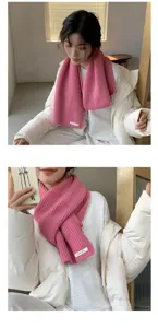 Pink knit scarf detail shot, cozy winter style, soft woolen texture, warm neck wrap.
