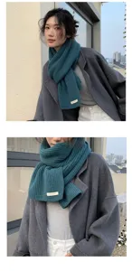 Detail view of the cozy knitted scarf worn by model, showing soft texture and close-up details.