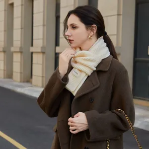 Detailed view of the cozy beige knitted scarf worn outdoors, highlighting its soft ribbed texture.