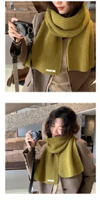 Green knit scarf detail view, stylish winter warm knitted neck warmer lifestyle display.