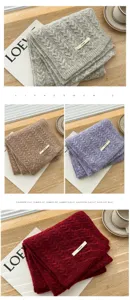Detailed close-up view of cozy winter cable knit scarf featuring soft woolen texture.