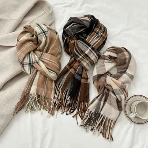 Detail shot of autumn and winter imitation cashmere plaid scarf featuring elegant fringes.