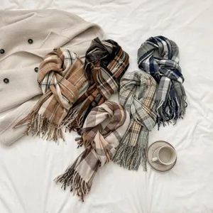 Detail view of winter plaid imitation cashmere scarf with sweet tassels and cozy couple style.