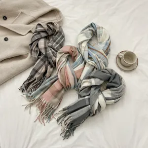 Detailed view of cozy imitation cashmere plaid scarf with cute tassels, perfect for autumn winter.