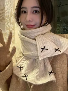 Cozy milky white knitted winter scarf featuring cute black bow decorations for women.