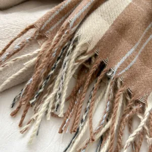 Close up detail of autumn winter imitation cashmere plaid fringe scarf cozy neck warmer.