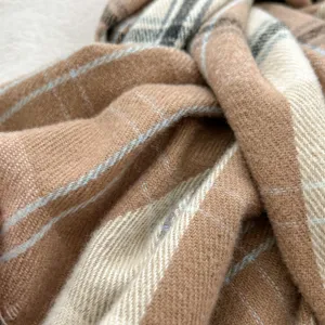 Detail view of cozy imitation cashmere plaid scarf showing soft textured camel and white checks.