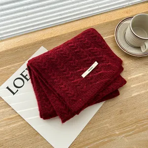 Classic red knitted cable scarf for women, warm and cozy winter neck wrap accessory.