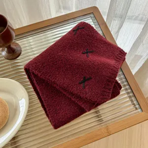 Cozy wool blend knit scarf in dark red with cute bow details, warm and stylish winter accessory.