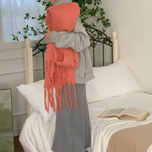 Cozy winter mohair tassel scarf for women, soft solid color thick knit warmth accessory.