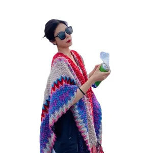 Ethnic style knitted poncho for women, colorful geometric pattern tassel cape and shawl.