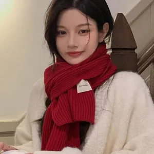 Red knitted winter scarf for women, warm and thick wool neck warmer with stylish woven label.