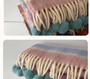Close-up detail shot of the colorful rainbow mohair scarf featuring tassels and pom-poms.