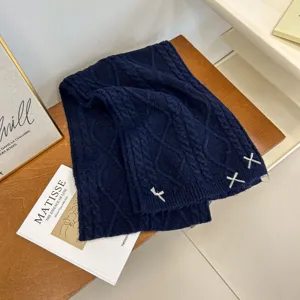 Cozy dark blue knitted winter scarf featuring cute white ribbon bows, thick and warm for women.