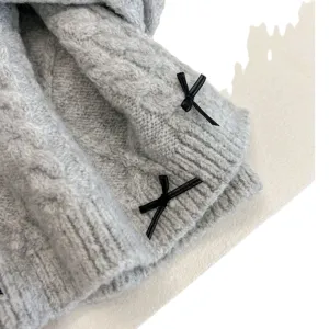 Cozy grey knit winter scarf with cute black bow decorations. Soft thick warm neck warmer for women.