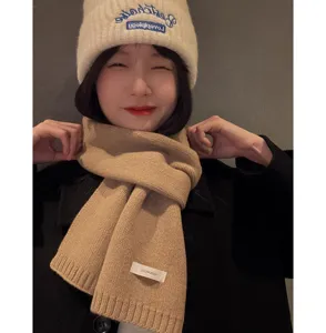 Winter warm knitted scarf and beanie set in solid beige, soft woolen material for cold days.