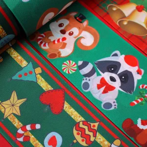Detailed view of 75mm Christmas grosgrain ribbon with festive animal prints for gift wrapping.