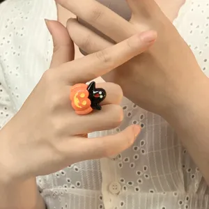 Halloween pumpkin ghost ring detail view, quirky cute finger jewelry accessory for party.