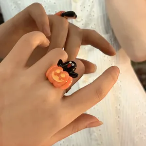 Halloween pumpkin and ghost ring detail shot, glossy resin, funny and cute jewelry.