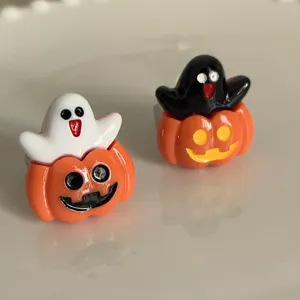 Close-up detail of Halloween ghost pumpkin rings showcasing quirky resin design and vivid colors.