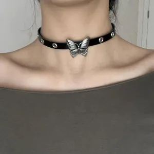 Close-up detail of gothic black leather choker necklace featuring a retro silver butterfly pendant.