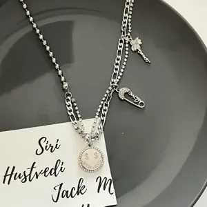 Multi-layer silver metal necklace with rhinestones, dollar pendant, and trendy design for women.