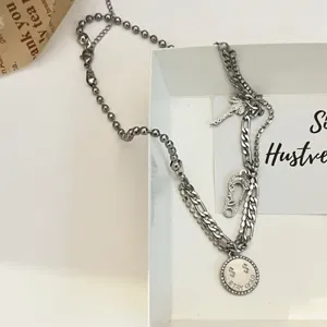 Stainless steel multi-layer necklace with coin and key pendants for women streetwear chic.
