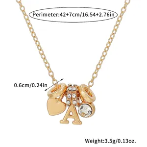 Close-up detail shot of a gold-plated multi-charm pendant necklace with sparkling rhinestones.
