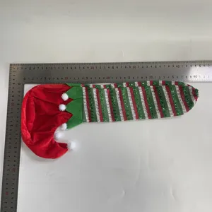 Christmas elf leg chair corner cover with red green stripes and white pom-pom detail