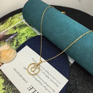 Detailed view of the gold zodiac Taurus pendant necklace with sparkling cubic zirconia on display.