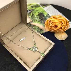 Close-up view of the exquisite green butterfly pendant necklace detail, elegant style.