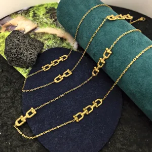 Detailed closeup of the luxury titanium steel U-link horseshoe necklace, elegant gold finish.