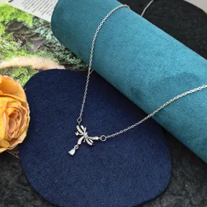 Close-up of the silver hollow dragonfly necklace with intricate rhinestones and fine chain.