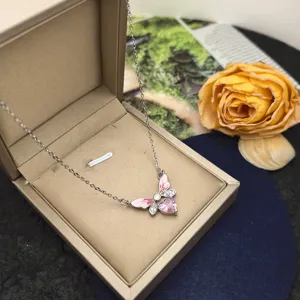 Exquisite butterfly heart pendant necklace detail in elegant beige jewelry gift box display.