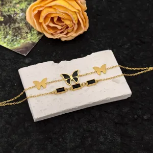 Elegant double layer titanium steel chain bracelet with chic butterfly and black stone details.