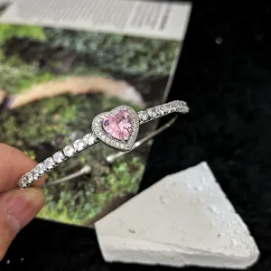 Close-up detail of the stunning silver-tone bracelet featuring a sparkling pink heart zircon.