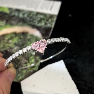 Silver-tone bracelet featuring a sparkling pink heart-shaped zircon and delicate crystal stones.