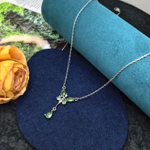 Silver-color clavicle chain necklace featuring a delicate green butterfly and teardrop pendant.
