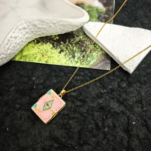 Dainty gold-plated necklace featuring a cute pink enamel book locket pendant with crystal.