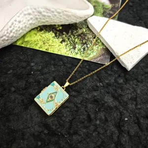 Close-up of the blue enamel book pendant necklace with fine gold chain and sparkling rhinestone.