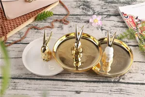 Detail view of luxury ceramic rabbit ring holder tray in gold and white, perfect desktop organizer.