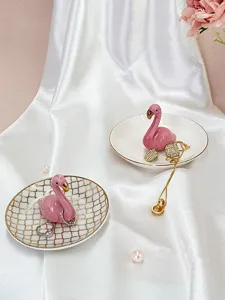 Nordic style ceramic flamingo jewelry tray with gold trim, perfect for rings and necklaces.