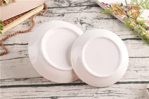 Detailed view of white ceramic jewelry storage trays showcasing smooth glazed bottom surfaces.