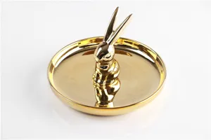 Gold ceramic rabbit jewelry dish and ring holder for vanity, elegant desktop decor tray.